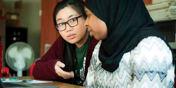 Catalyze coach works with student at table